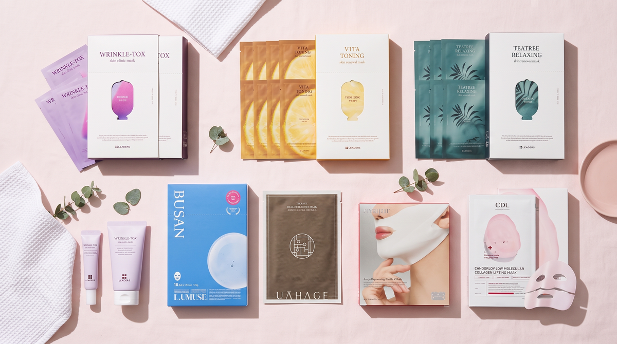 Korean sheet masks from LEADERS, LUMUSE, UAHAGE, AVAJAR and Candorlov on a pink backdrop