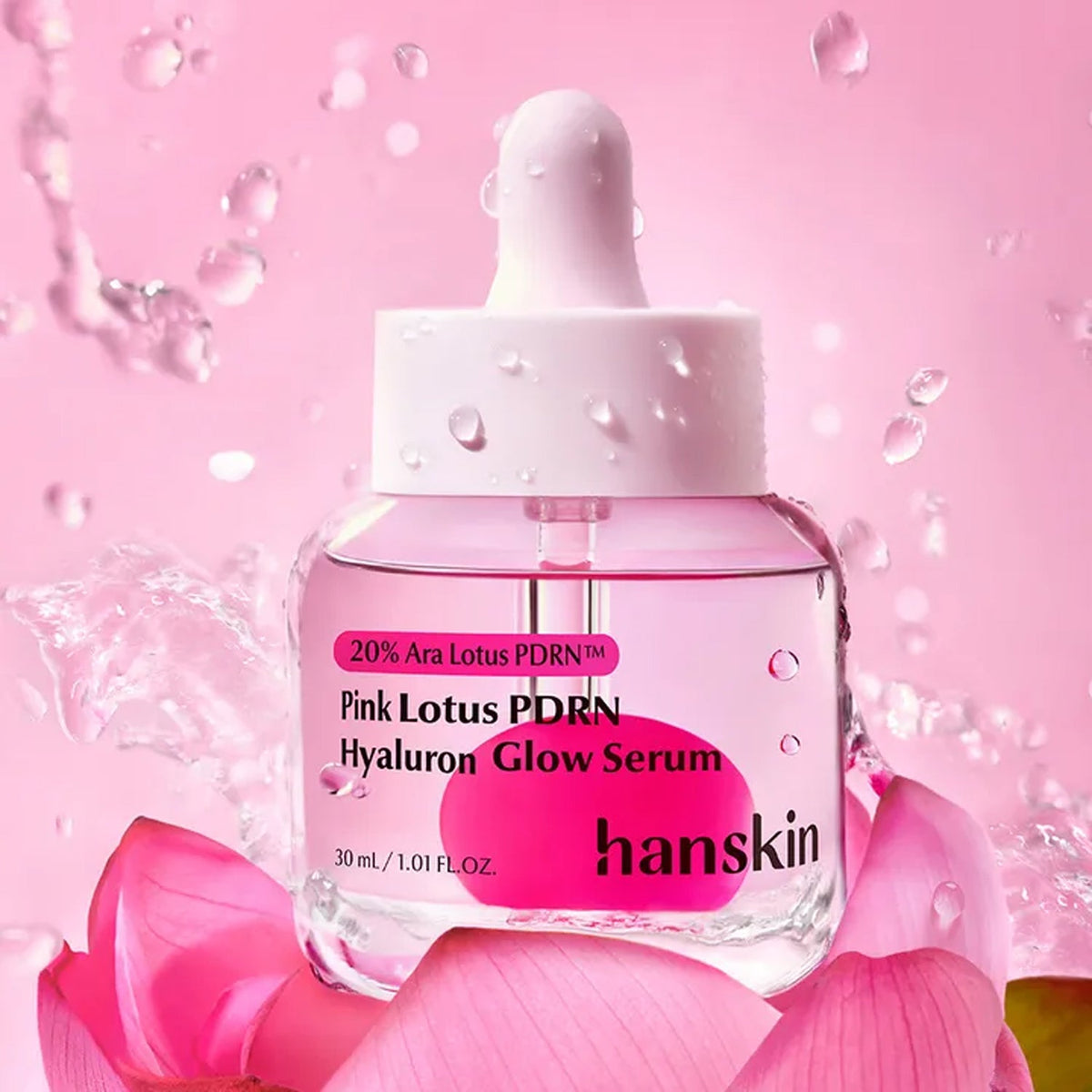 Hanskin Pink Lotus PDRN Hyaluron Glow Serum 1.01 fl oz (30 ml) — pink serum dropper bottle with water droplets