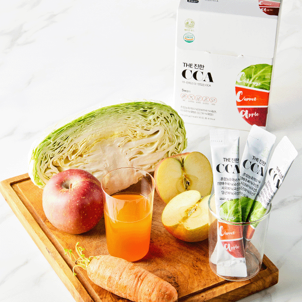 Very Good Food THE Jinhan CCA Juice Sticks with cabbage, apples and carrot on a cutting board