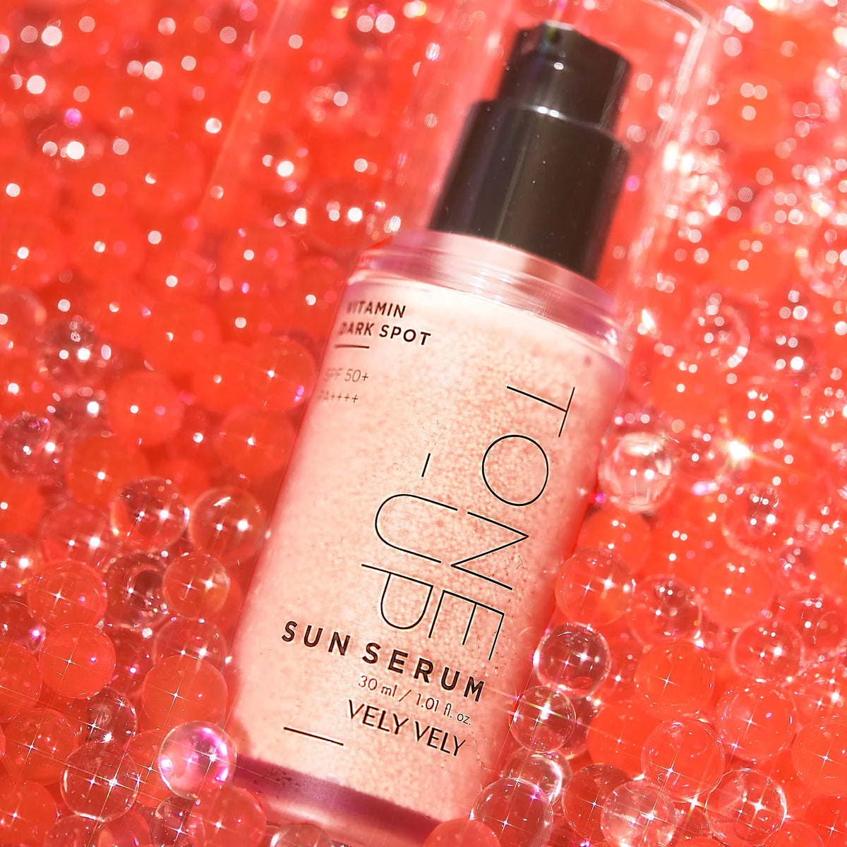 Tone-Up Sun Serum bottle on a pink background