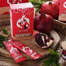 Wellural Red Scandal Pomegranate Jelly Sticks box and sticks with cut pomegranates